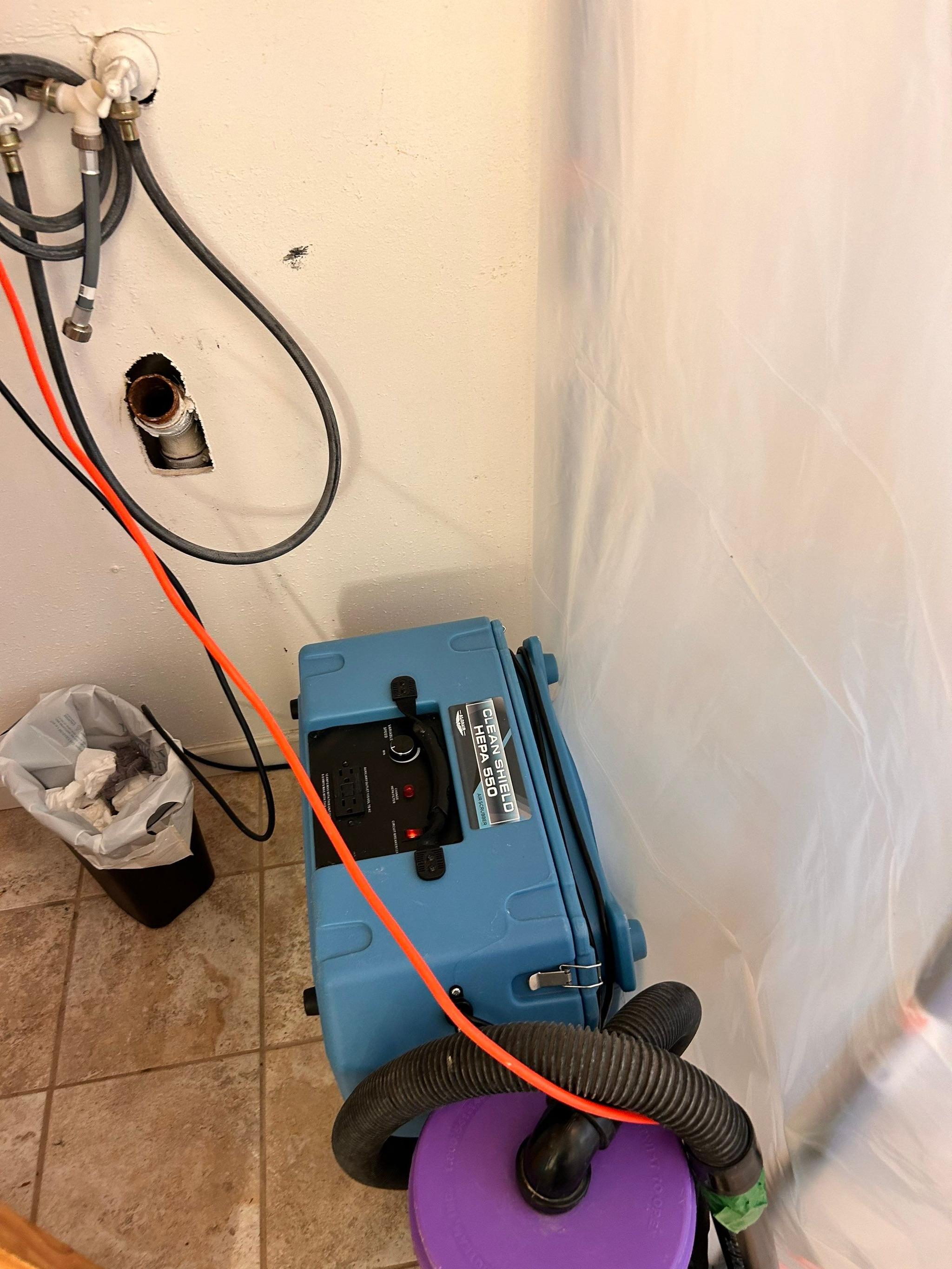 Containment barrier and dehumidifier set up during the remediation phase of a St. Charles County water loss